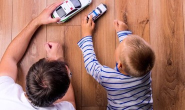 Father and son playing on laminate flooring | Speers Road Broadloom
